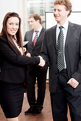 Image showing business woman and man shake hands in office