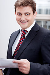 Image showing business man with tie and suit with documents 