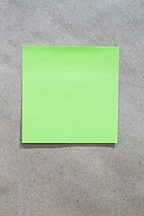 Image showing Brown gradient paper background with green note paper 