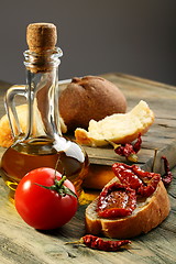 Image showing Sun dried tomatoes, white bread and olive oil.