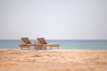 Image showing Bamboo loungers on the beach