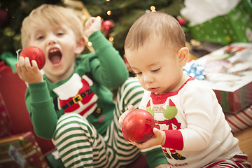 Image showing Mixed Race Baby and Young Boy Enjoying Christmas Morning Near Th