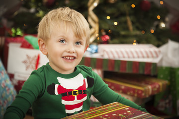 Image showing Young Boy Enjoying Christmas Morning Near The Tree