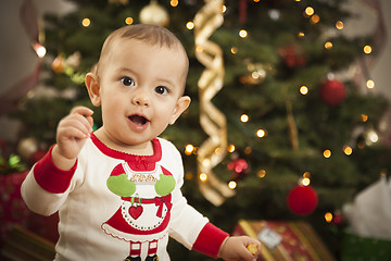 Image showing Infant Mixed Race Baby Enjoying Christmas Morning Near The Tree