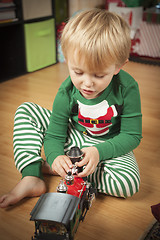 Image showing Young Boy Enjoying Christmas Morning Near The Tree