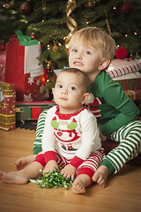 Image showing Mixed Race Baby and Young Boy Enjoying Christmas Morning Near Th