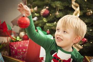 Image showing Young Boy Enjoying Christmas Morning Near The Tree