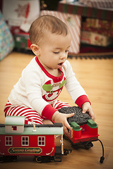 Image showing Infant Mixed Race Baby Enjoying Christmas Morning Near The Tree