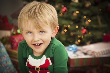 Image showing Young Boy Enjoying Christmas Morning Near The Tree