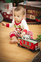 Image showing Infant Mixed Race Baby Enjoying Christmas Morning Near The Tree