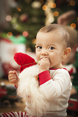 Image showing Infant Mixed Race Baby Enjoying Christmas Morning Near The Tree