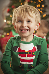 Image showing Young Boy Enjoying Christmas Morning Near The Tree