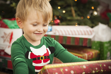 Image showing Young Boy Enjoying Christmas Morning Near The Tree