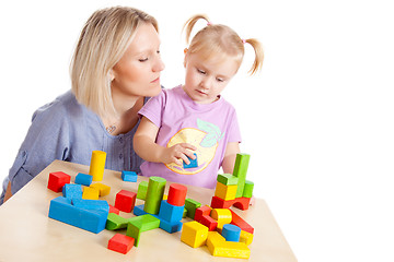 Image showing little girl and her mother playing with toy blocks