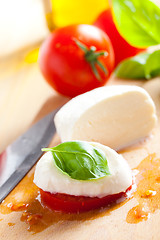 Image showing fresh mozzarella with tomato and basil