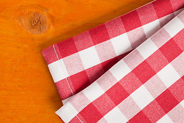 Image showing checkered napkin on wooden table