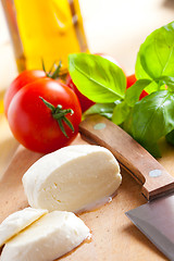 Image showing fresh mozzarella with tomato and basil