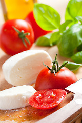 Image showing fresh mozzarella with tomato and basil