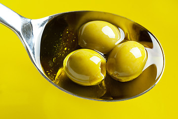 Image showing green olives in spoon with olive oil