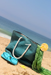 Image showing Blue bag on the seacoast with lollipop 