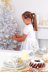 Image showing Cute girl decorating Christmas tree