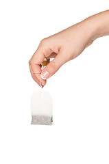 Image showing Hand with teabag