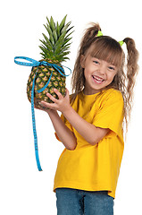 Image showing Little girl with pineapple