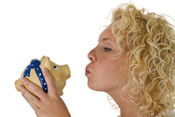 Image showing Young woman kissing big piggy bank