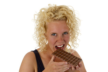 Image showing Young woman eating chocolate