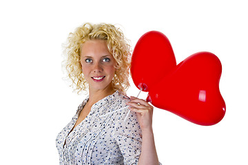 Image showing Young woman holding heart ballons