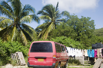 Image showing residential street scene van with laundry hanging palm  trees Cl