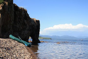 Image showing Fishing inflatable boat ashore at a rock
