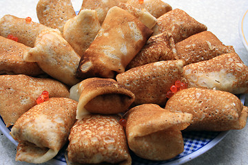 Image showing The well-known Russian pancakes with salmon caviar