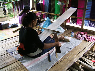 Image showing Woman working on a traditional handloom waeving