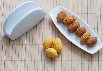 Image showing nuts on a plate next to the napkin