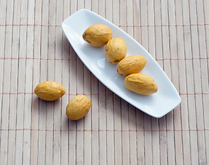 Image showing dish of nuts on a bamboo napkin