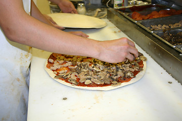 Image showing Topping The Pizza