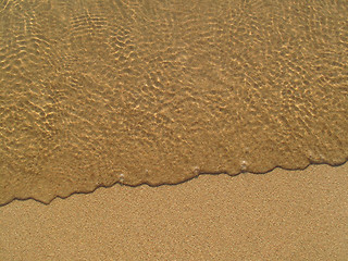 Image showing Transparent sea wave on the sand