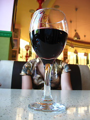 Image showing Glass of wine and the girl at restaurant