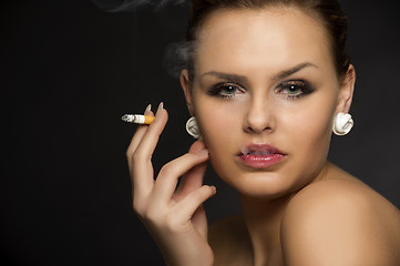 Image showing Stylish woman smoking a cigarette