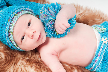 Image showing Newborn baby in long blue knitted hat