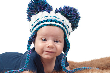 Image showing Cute baby in knitted hat with big pom-pons