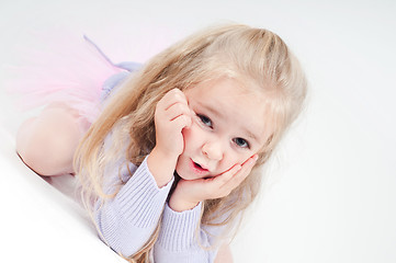 Image showing Cute blond girl sitting on the floor