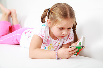 Image showing Small girl relaxing and reading