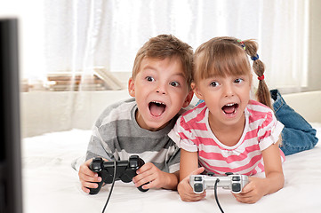 Image showing Happy girl and boy playing a video game