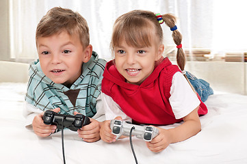 Image showing Happy girl and boy playing a video game