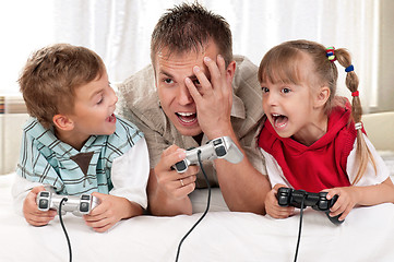 Image showing Happy family playing a video game