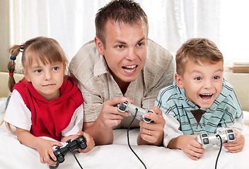 Image showing Happy family playing a video game