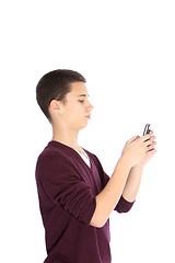 Image showing Teenage boy texting on his mobile