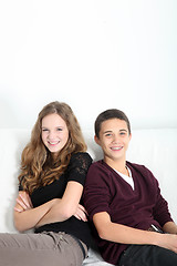 Image showing Happy teenage couple sitting together